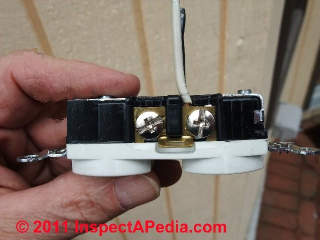 Binding head screw connector with copper wire on an electrical receptacle (C) Daniel Friedman
