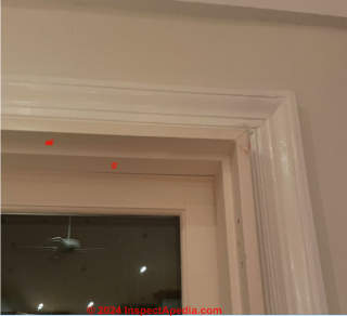 No asbestos hazard drilling screws into wood trim aound this asbestos-containing drywall (C) InspectApedia.com Joe