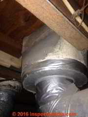 Asbestos fabric or reinforced paper on a heating duct and supply register (C) InspectApedia.com  SU 2016