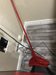 Is this small cutout in drywall an asbestos hazard ? (C) InspectApedia.com Vanessa Salas