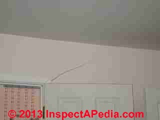 Drywall crack at doorway opening - building settlement (C) InspectApedia.com