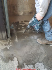 Cutting a concrete slab to install a bollard to protect an oil tank (C) Daniel Friedman at InspectApedia.com