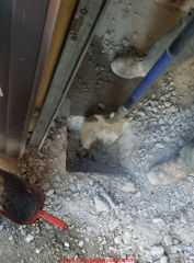 Cutting a concrete slab to install a bollard to protect an oil tank (C) Daniel Friedman at InspectApedia.com