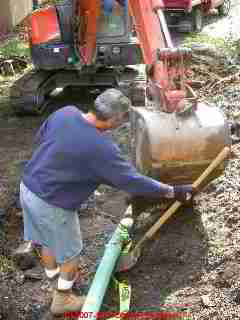 Photograph of installing plastic sewer drain line piping
